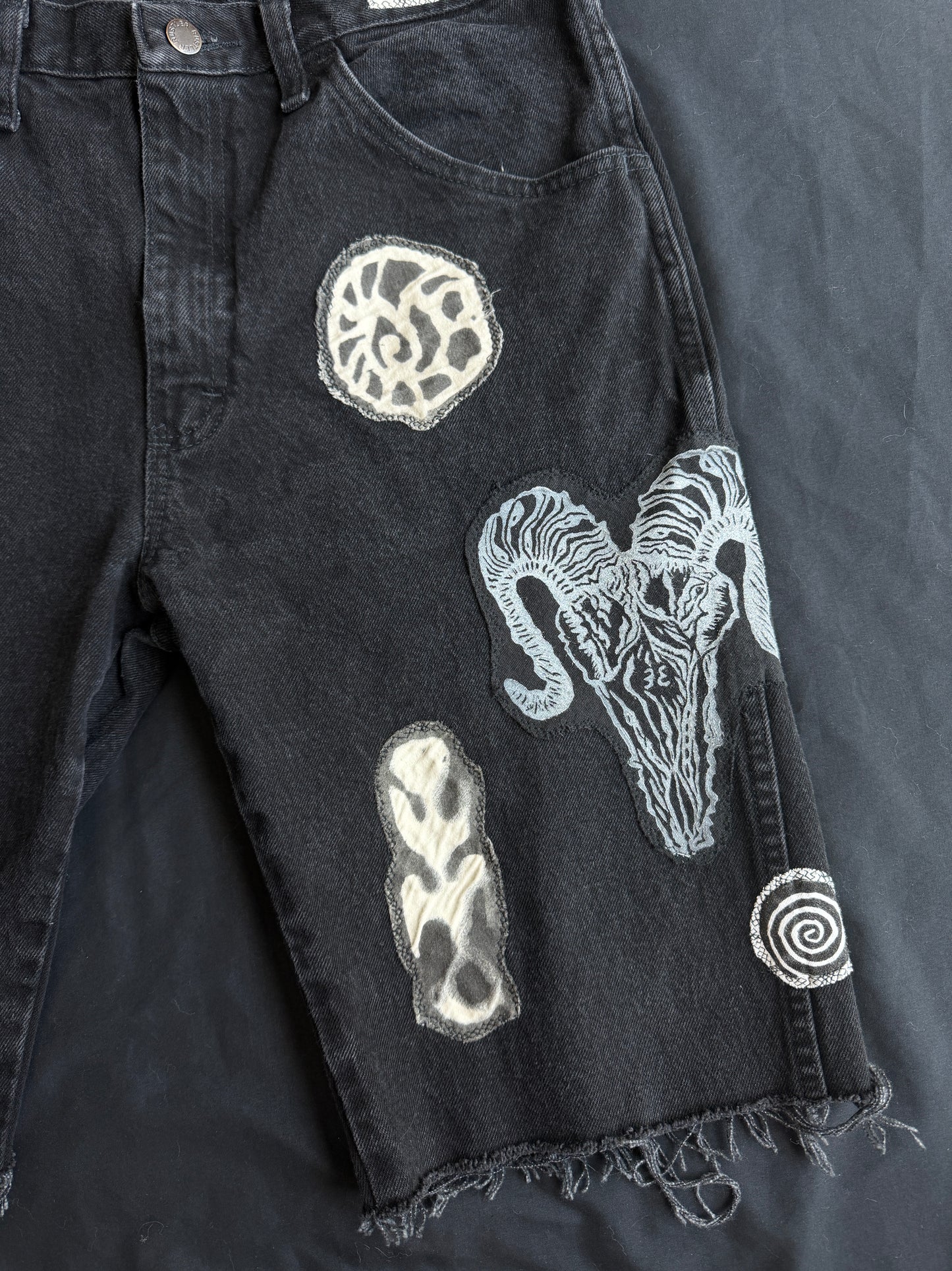 Black and white patch black jean shorts