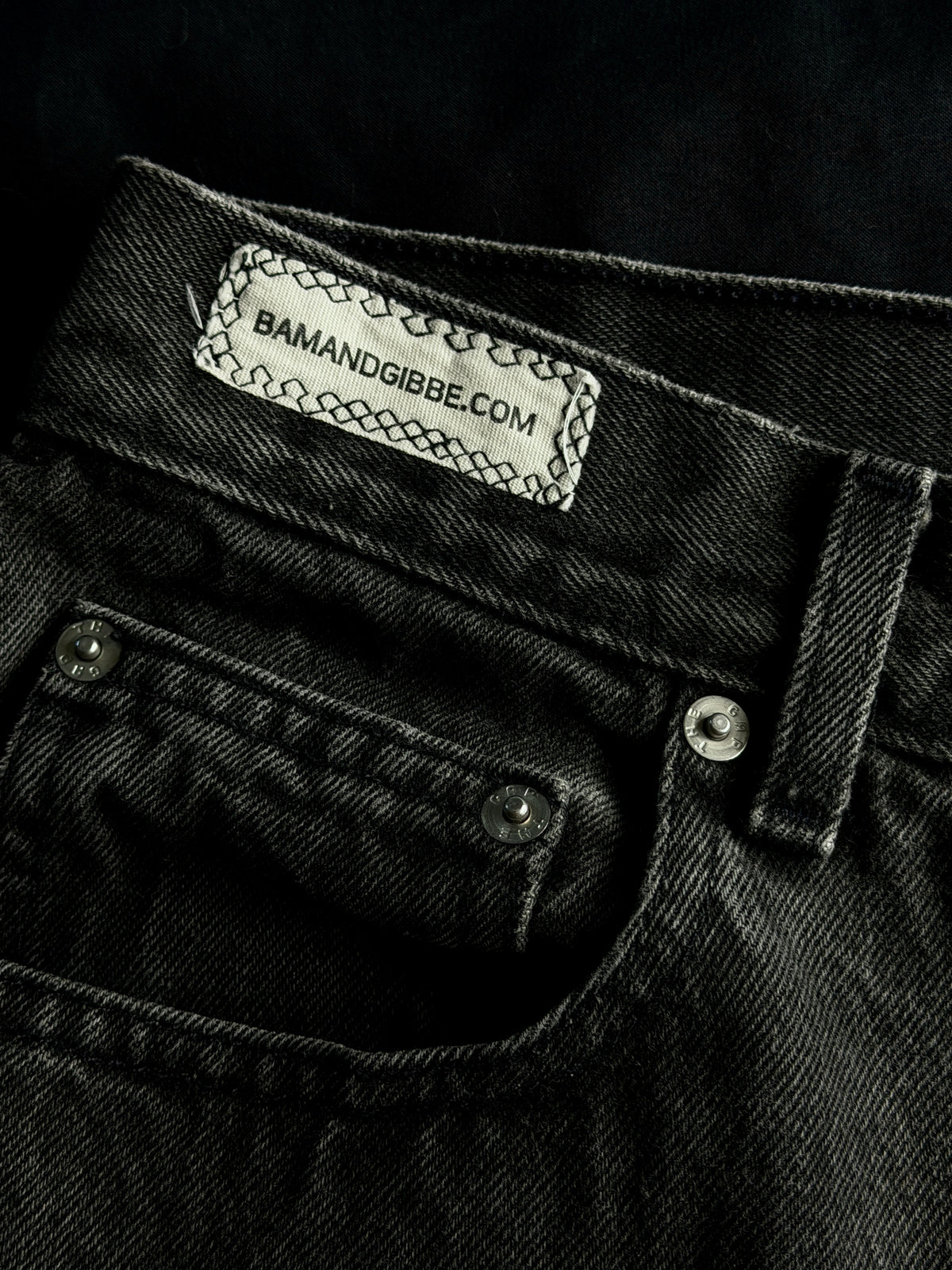 Patched black jean shorts