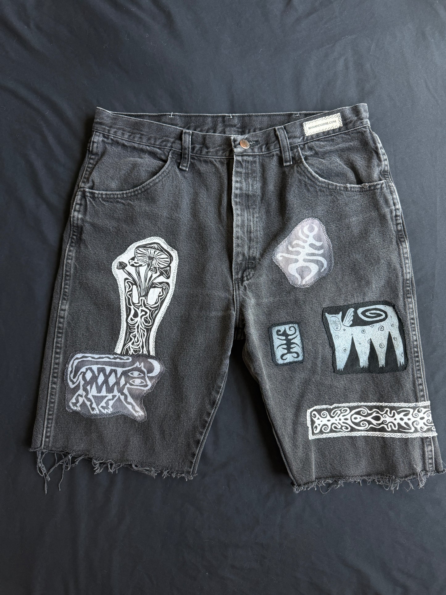 Black and white patch black jean shorts