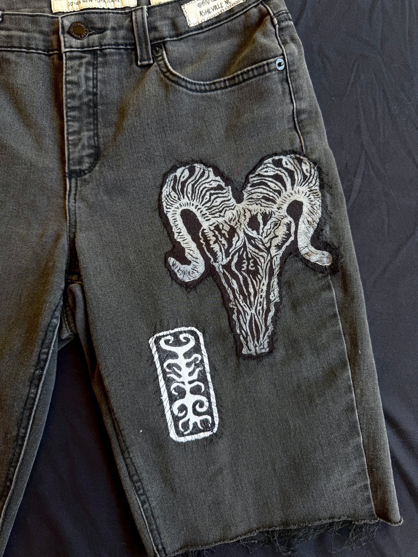 Black and white patch black jean shorts