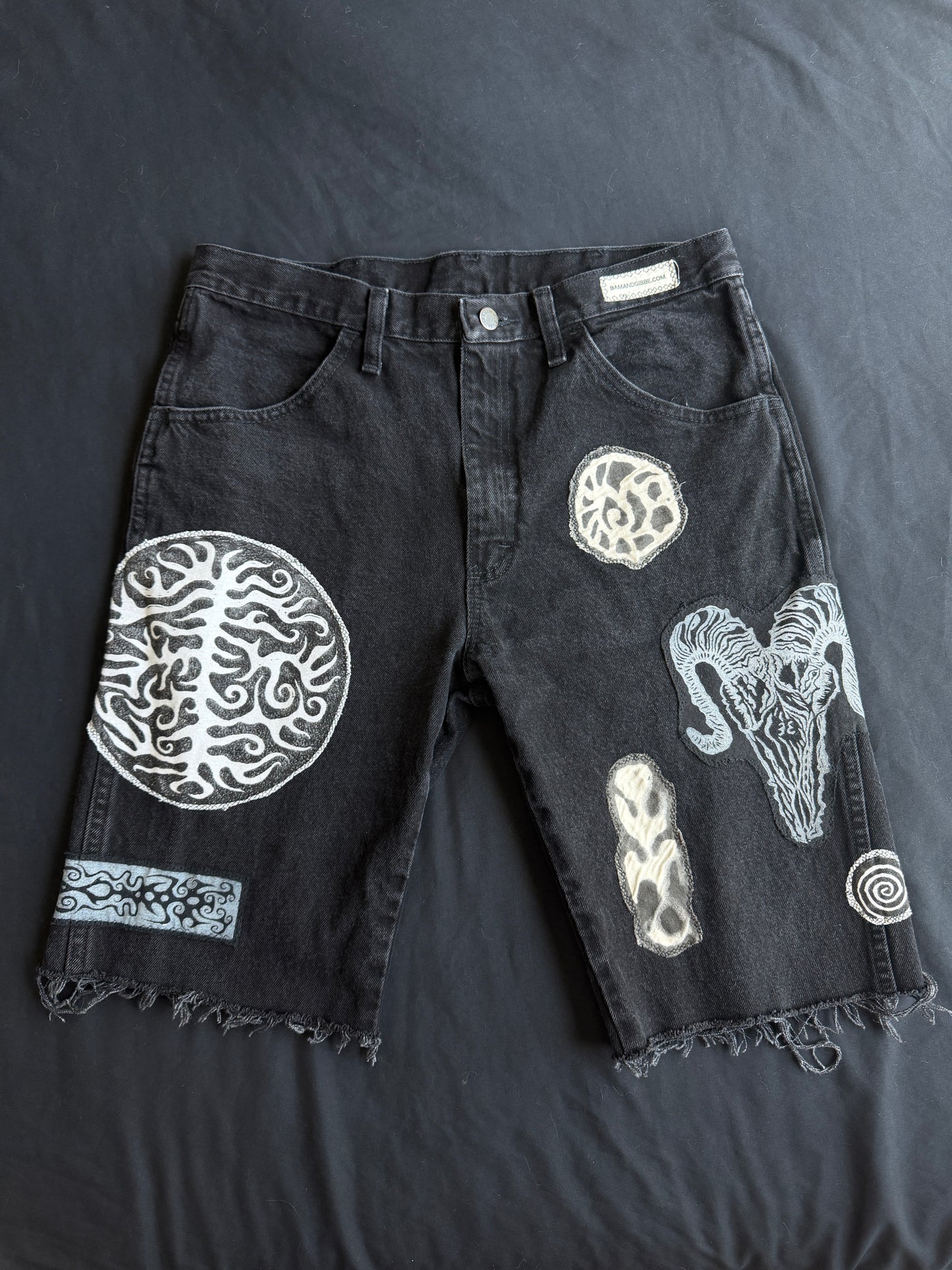 Black and white patch black jean shorts