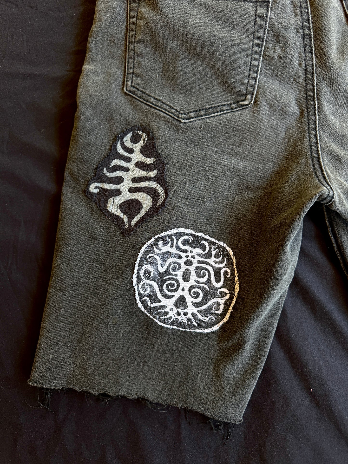Black and white patch black jean shorts