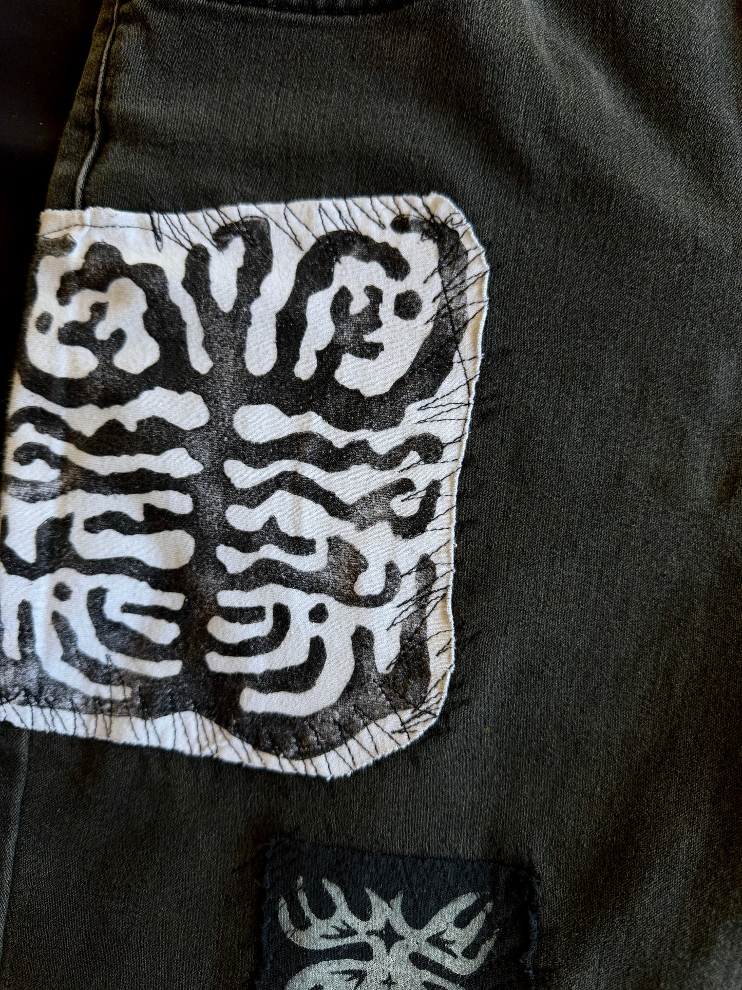 Black and white patch black jean shorts