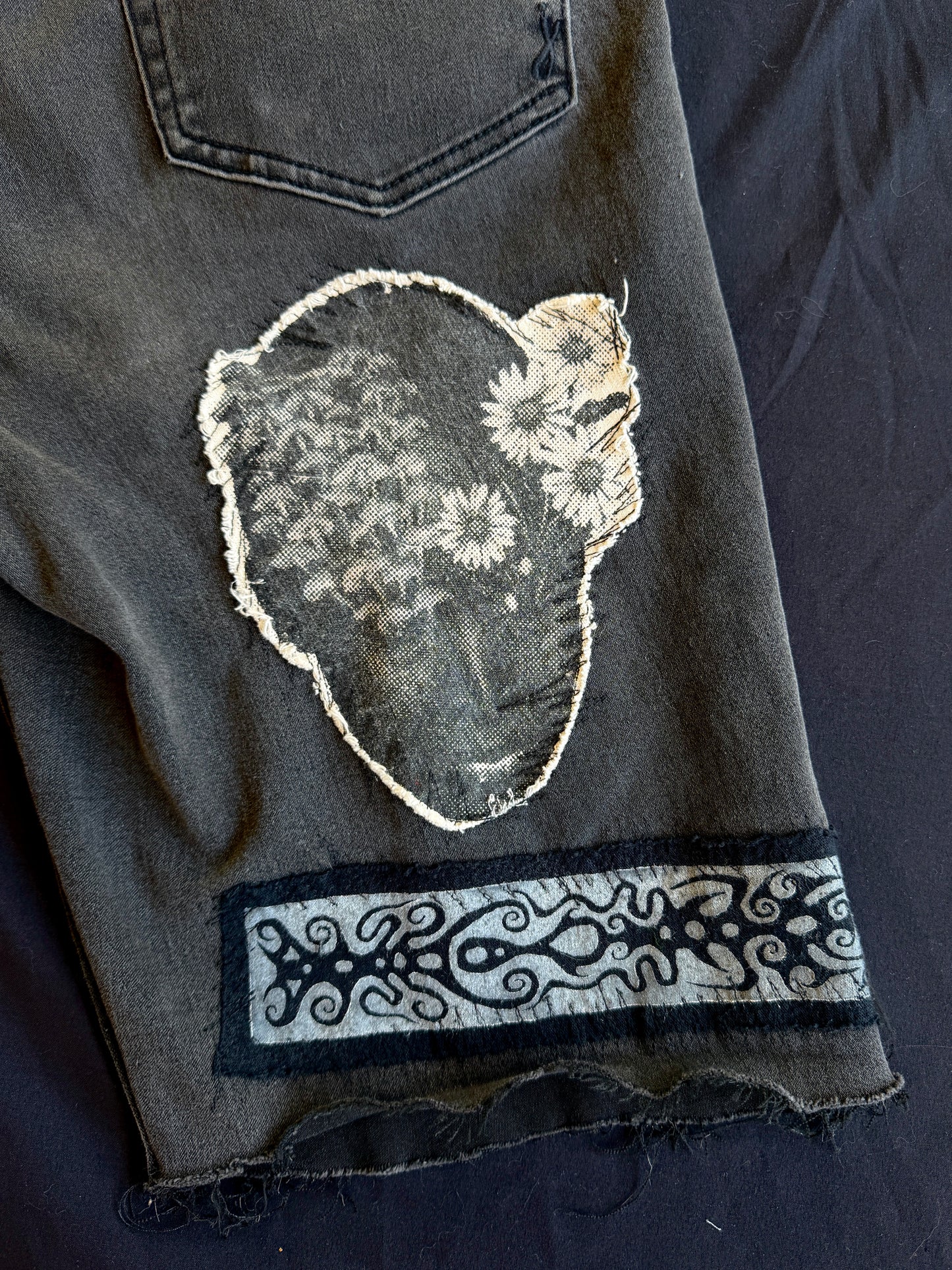 Black and white patch black jean shorts
