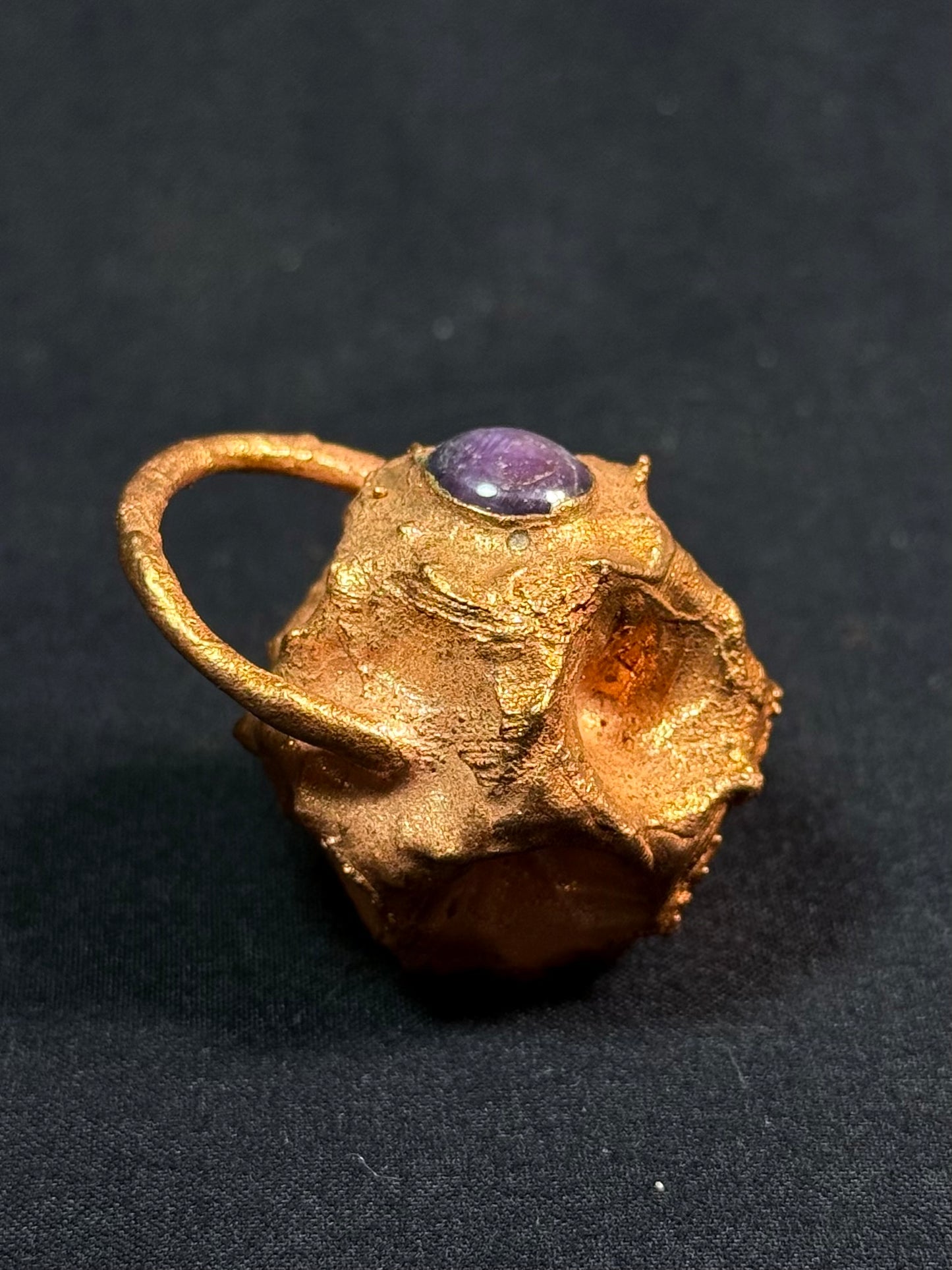 Tessellated rose star sapphire amulet