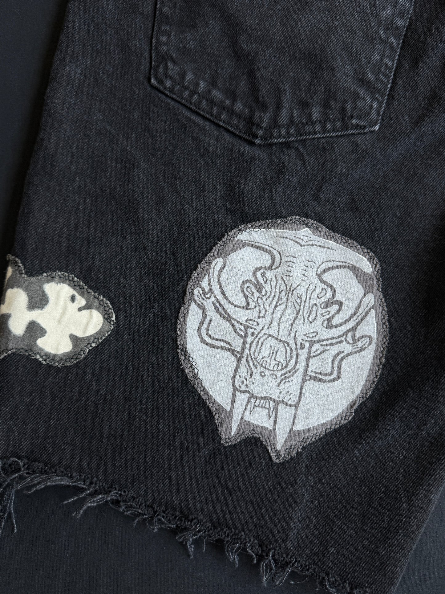 Black and white patch black jean shorts