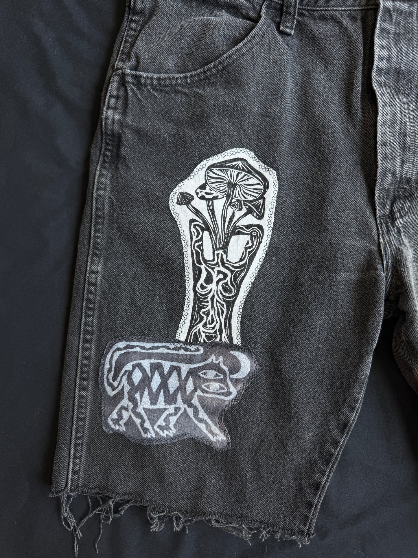 Black and white patch black jean shorts