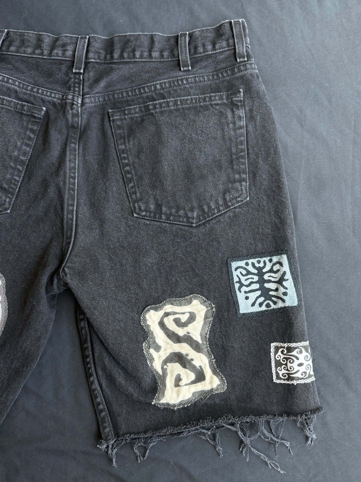 Black and white patch black jean shorts