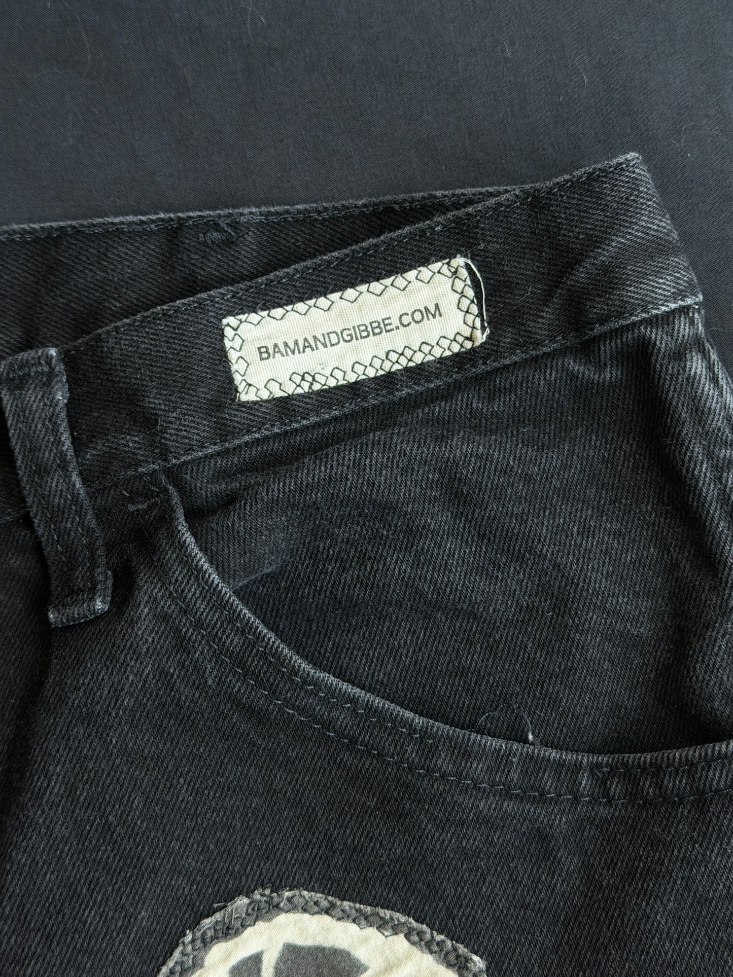 Black and white patch black jean shorts