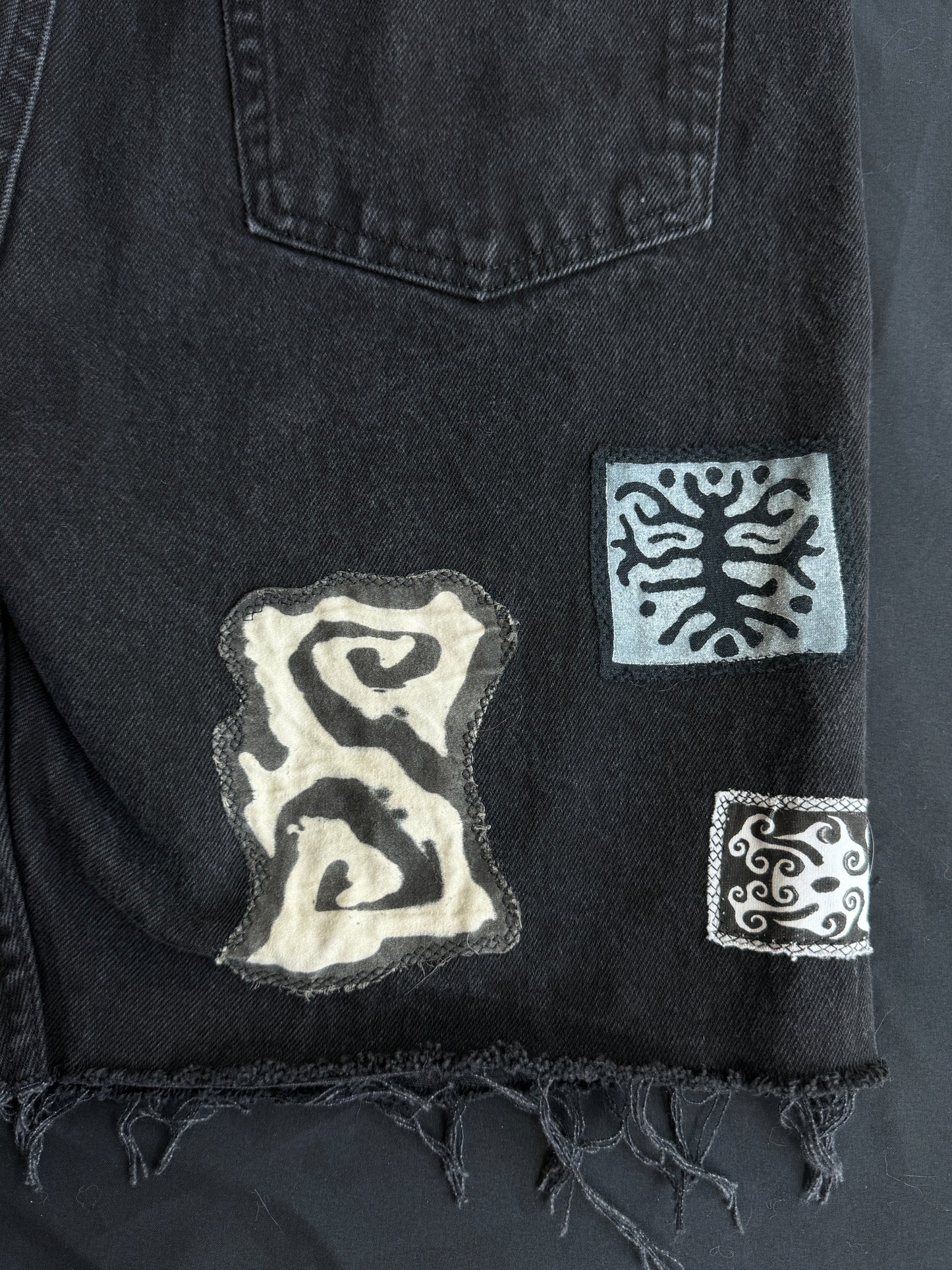 Black and white patch black jean shorts