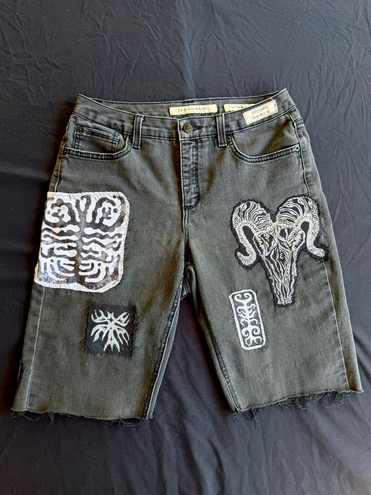 Black and white patch black jean shorts