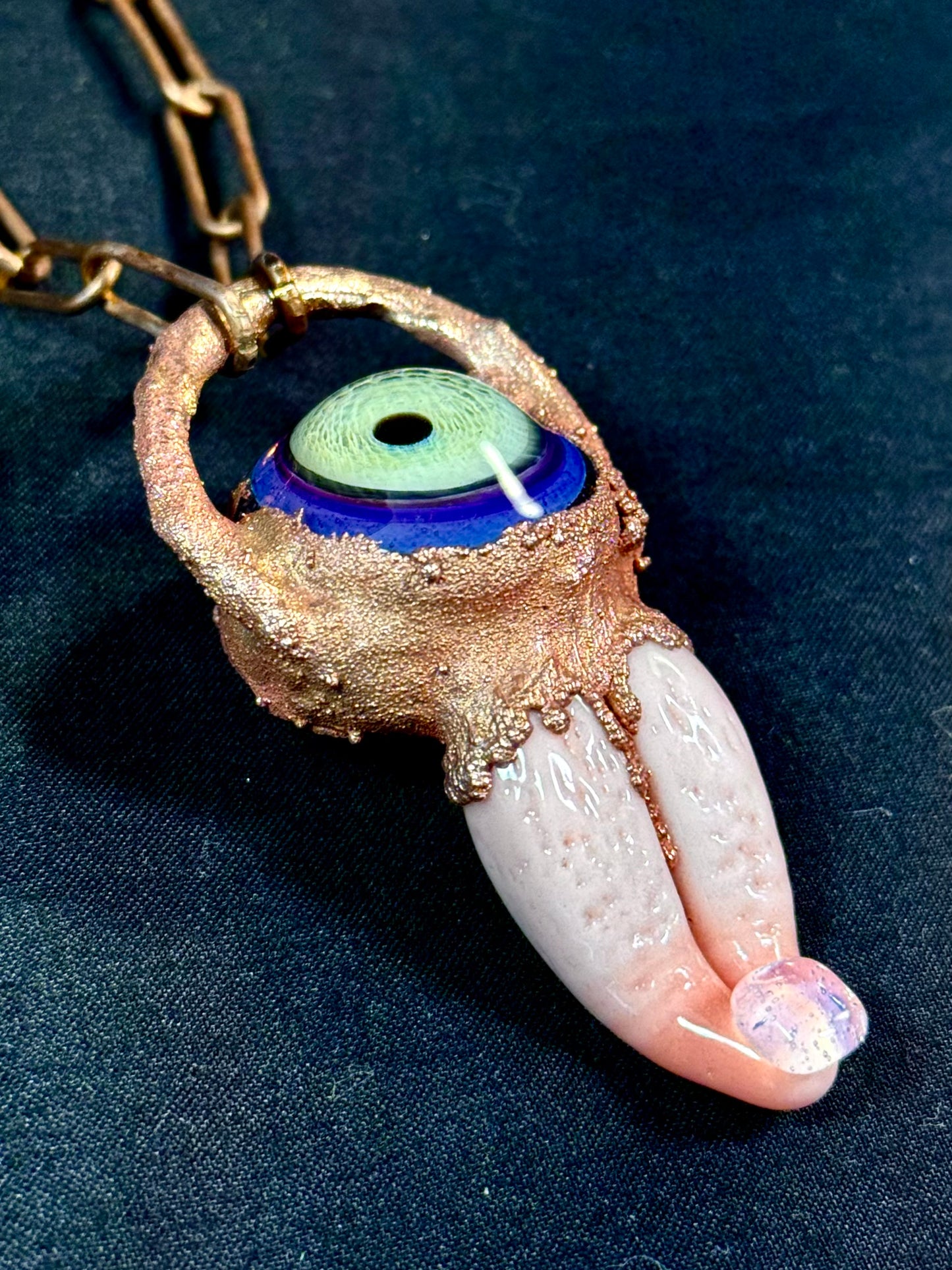 Glass tongue and eye amulet