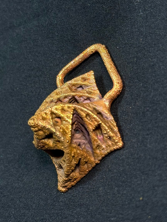 Warped pyramid amulet