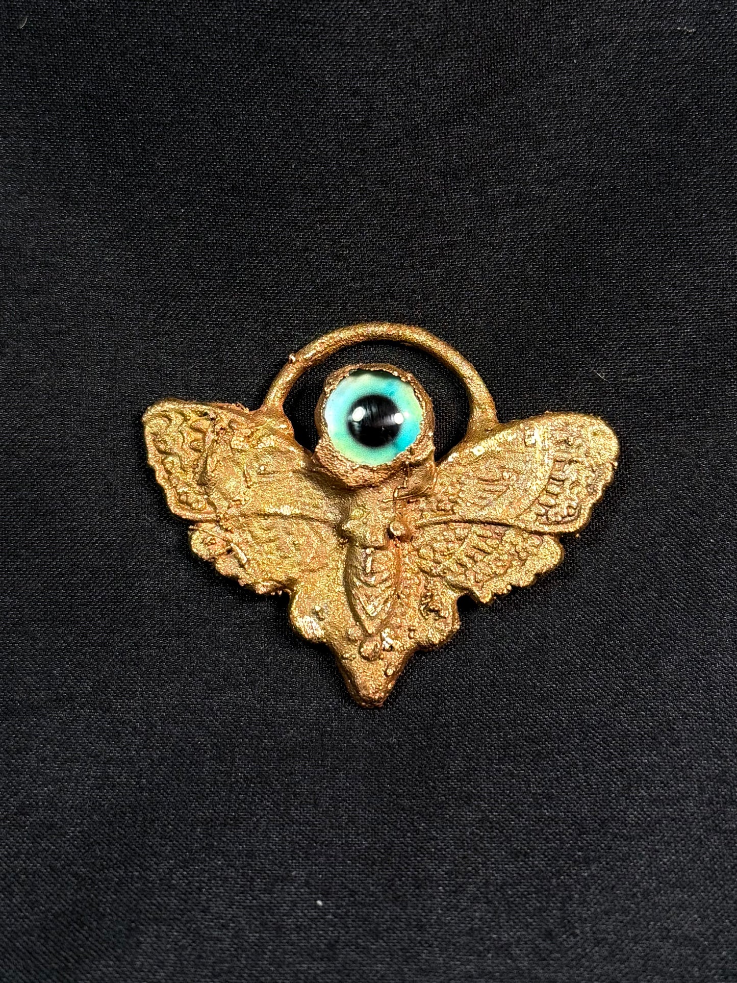 Eye moth amulet