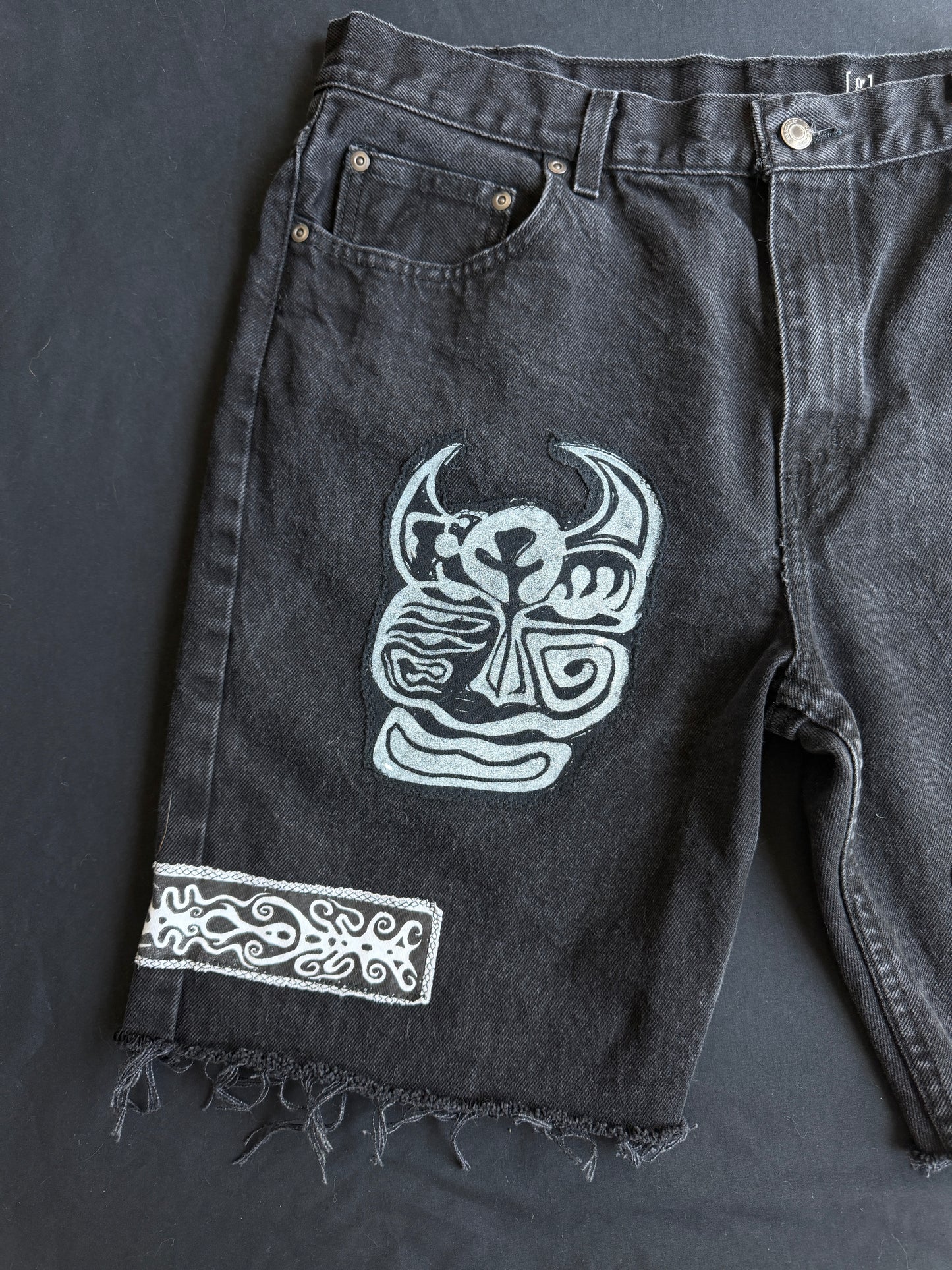 Black and white patch black jean shorts