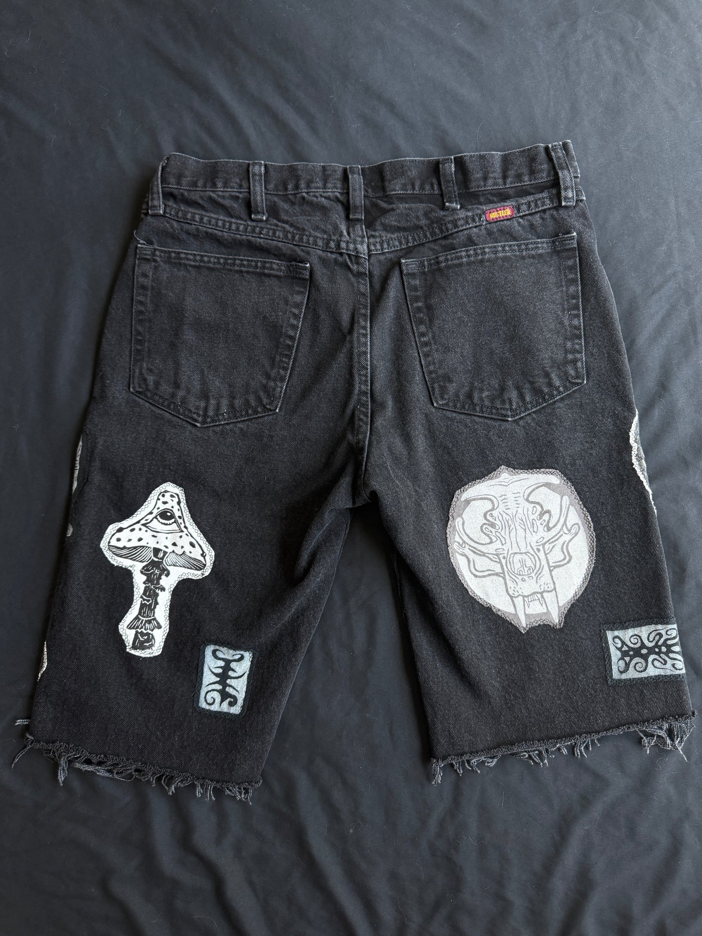Black and white patch black jean shorts