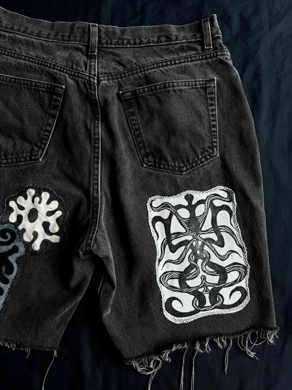 Patched black jean shorts