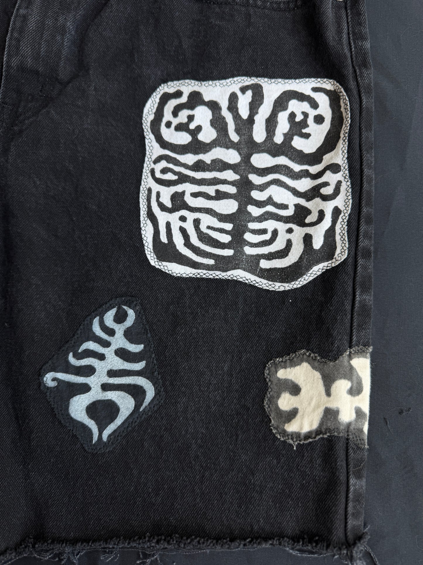 Black and white patch black jean shorts