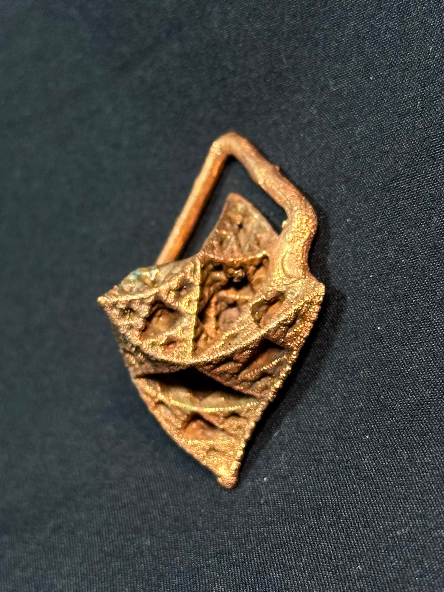 Warped pyramid amulet