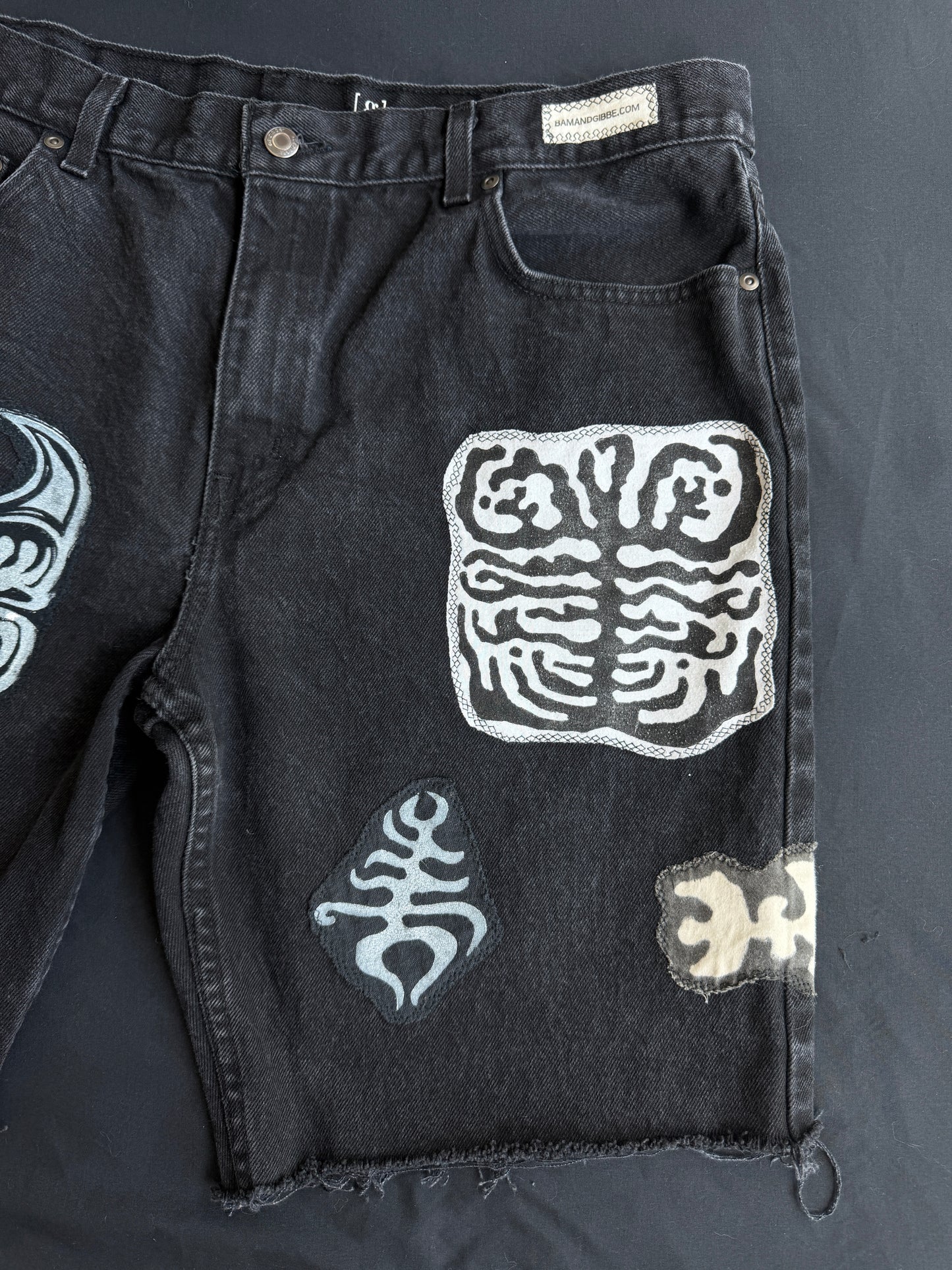 Black and white patch black jean shorts