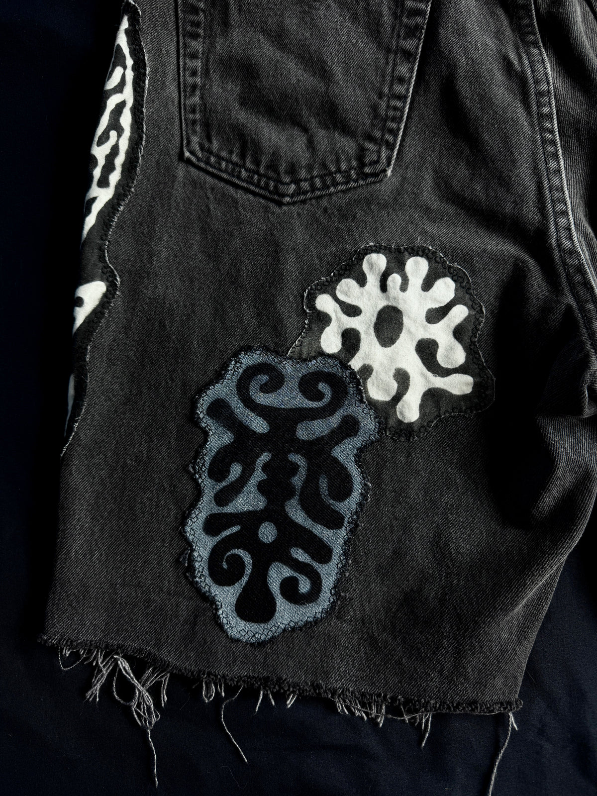 Patched black jean shorts