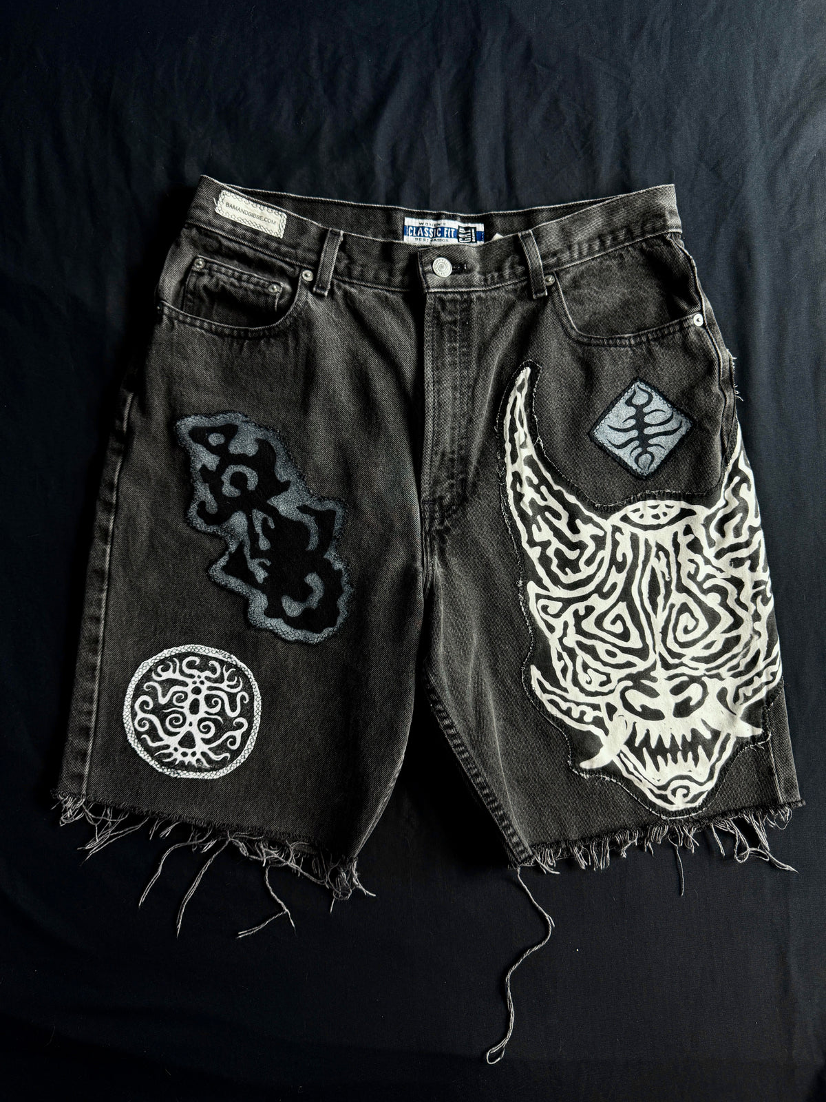 Patched black jean shorts