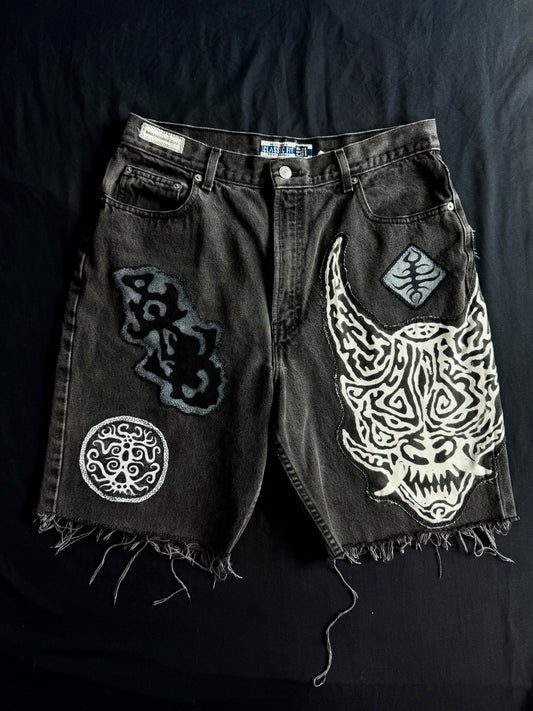 Patched black jean shorts