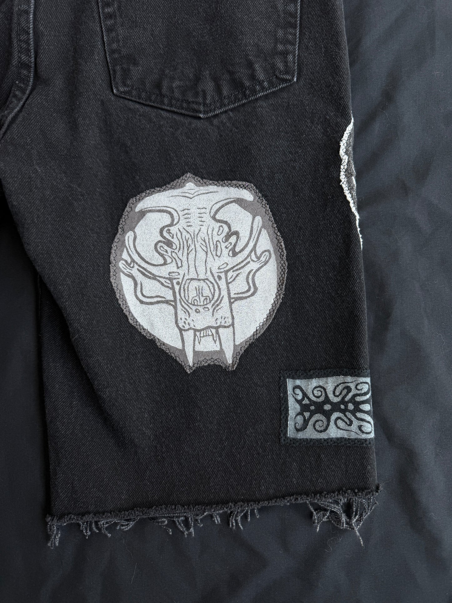 Black and white patch black jean shorts