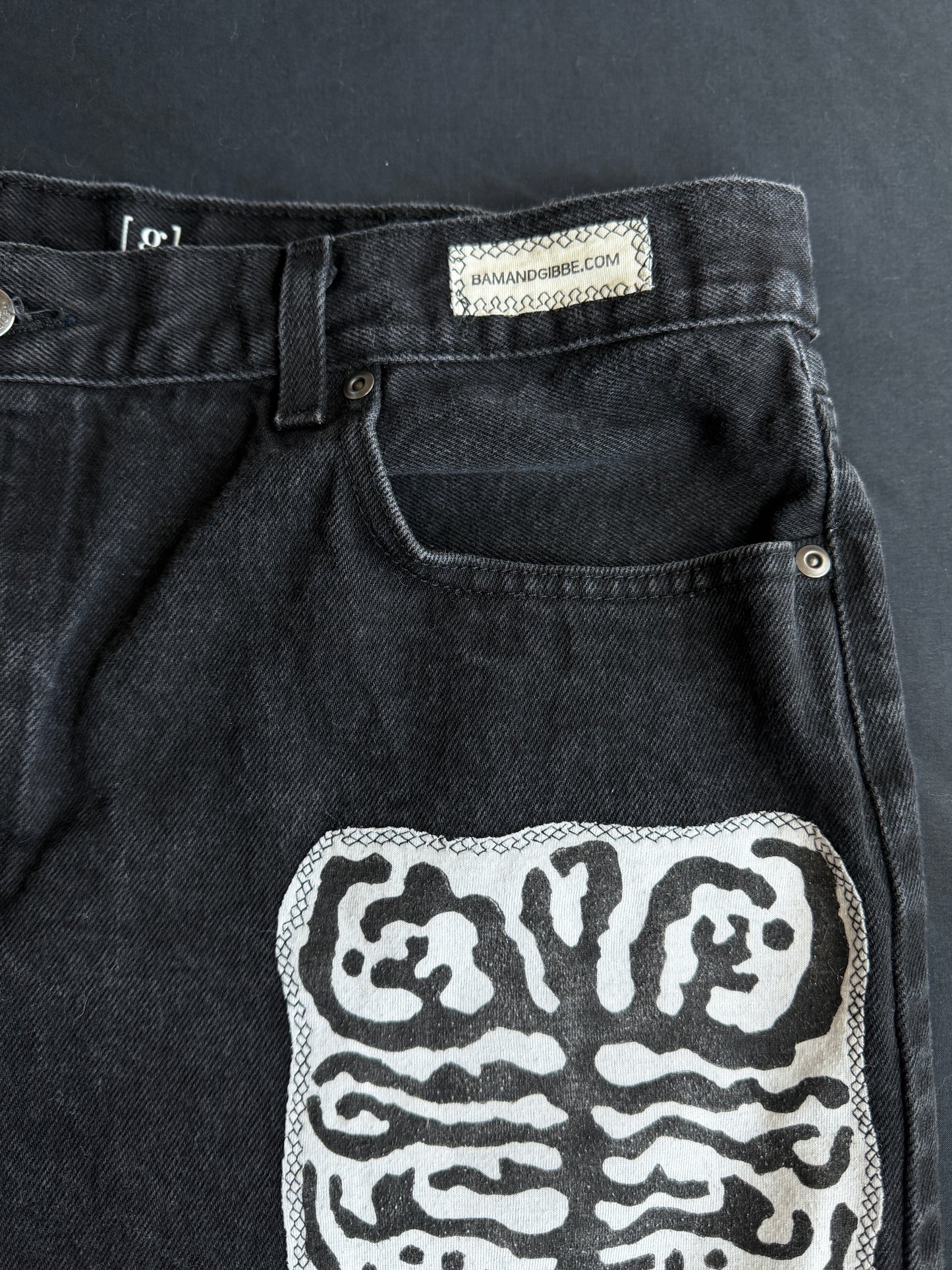 Black and white patch black jean shorts