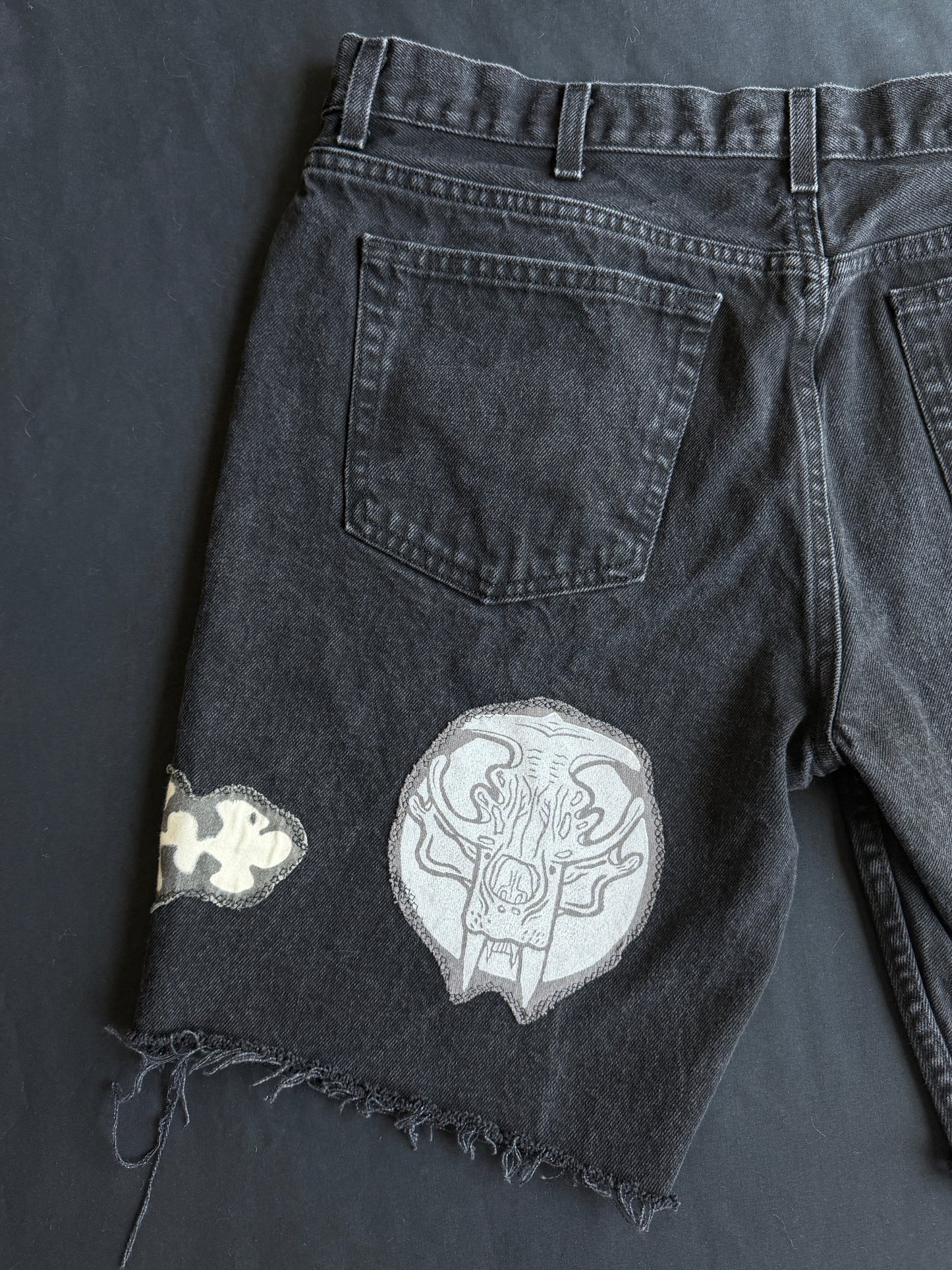 Black and white patch black jean shorts