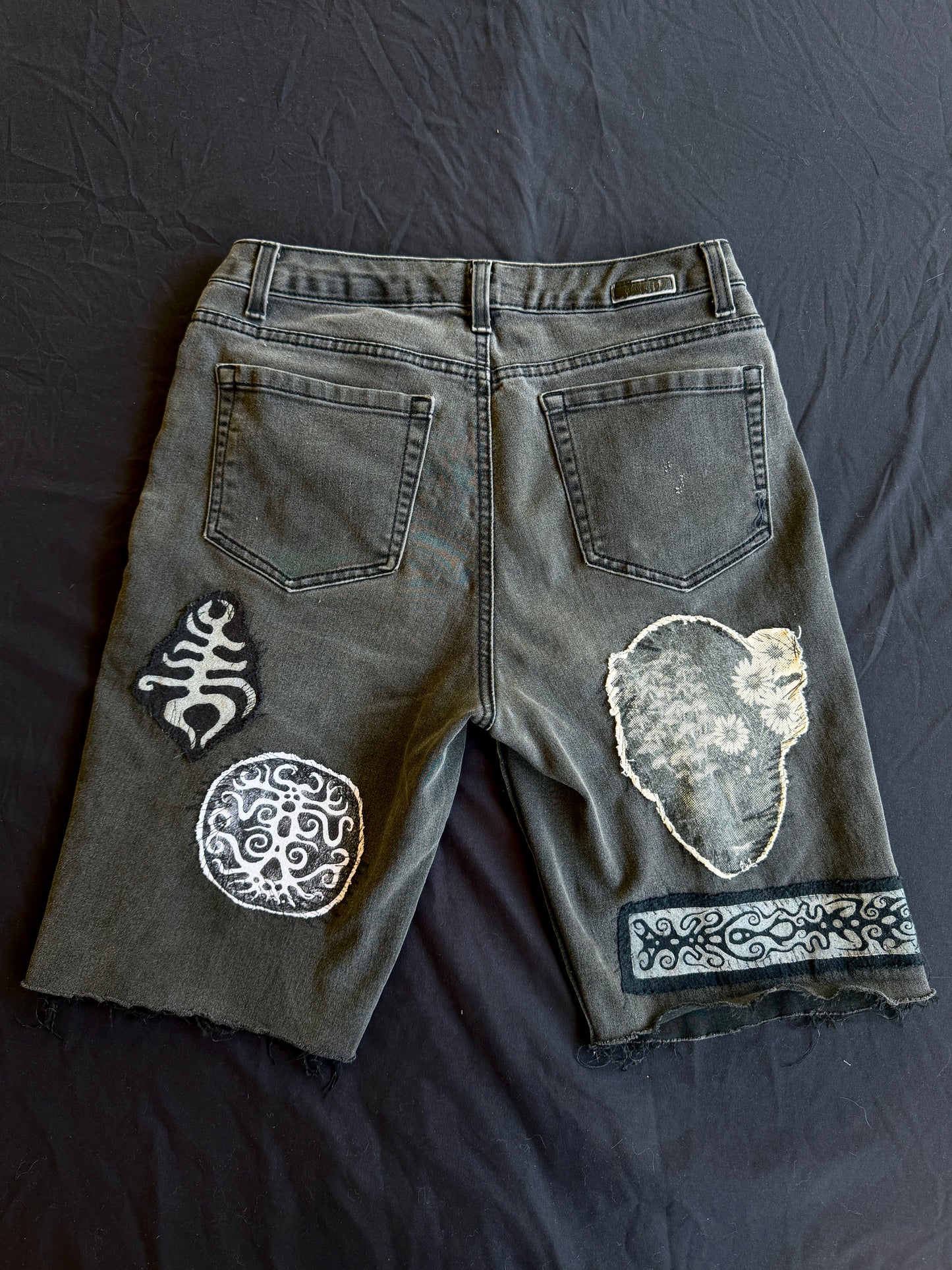 Black and white patch black jean shorts