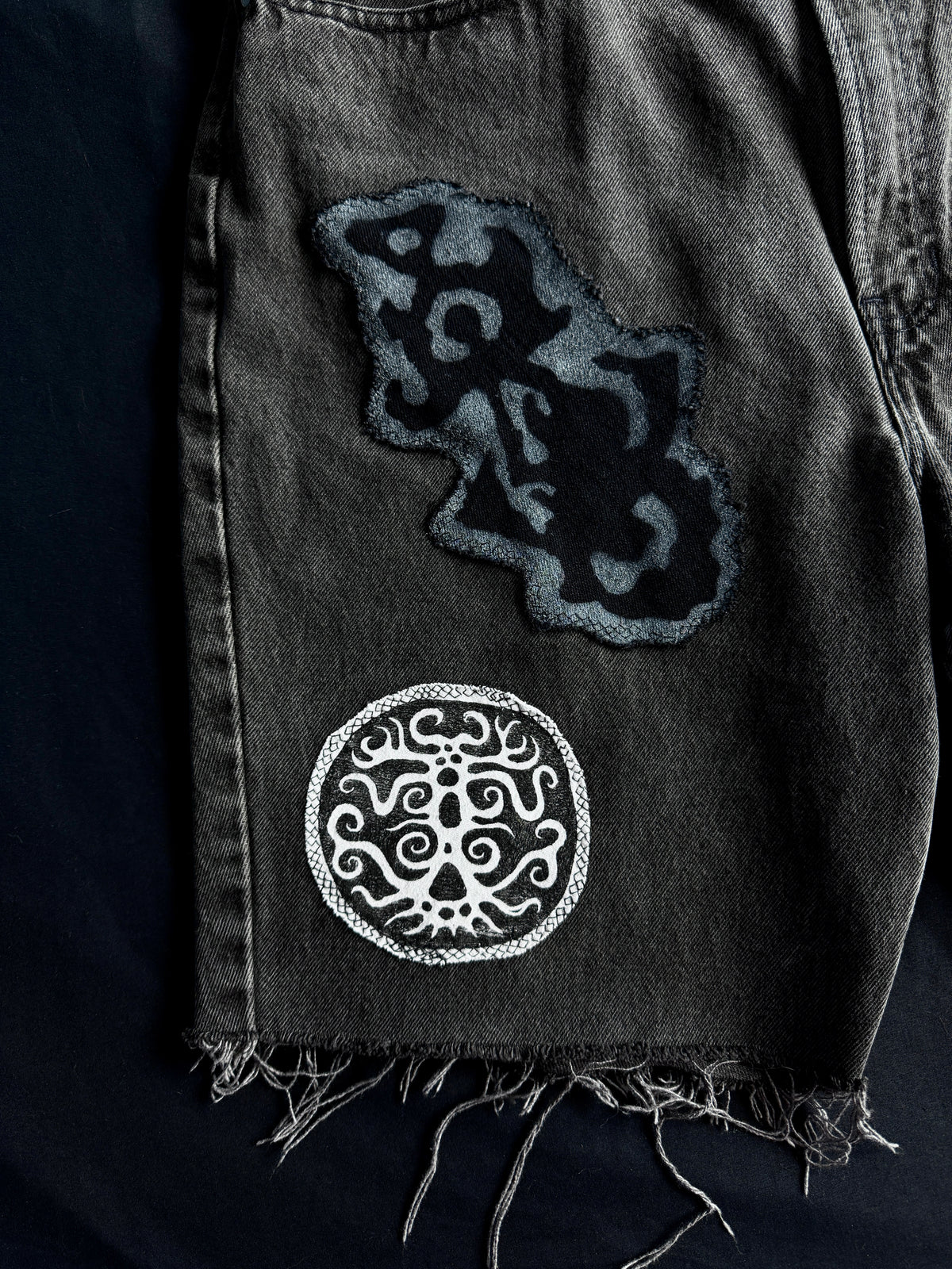 Patched black jean shorts
