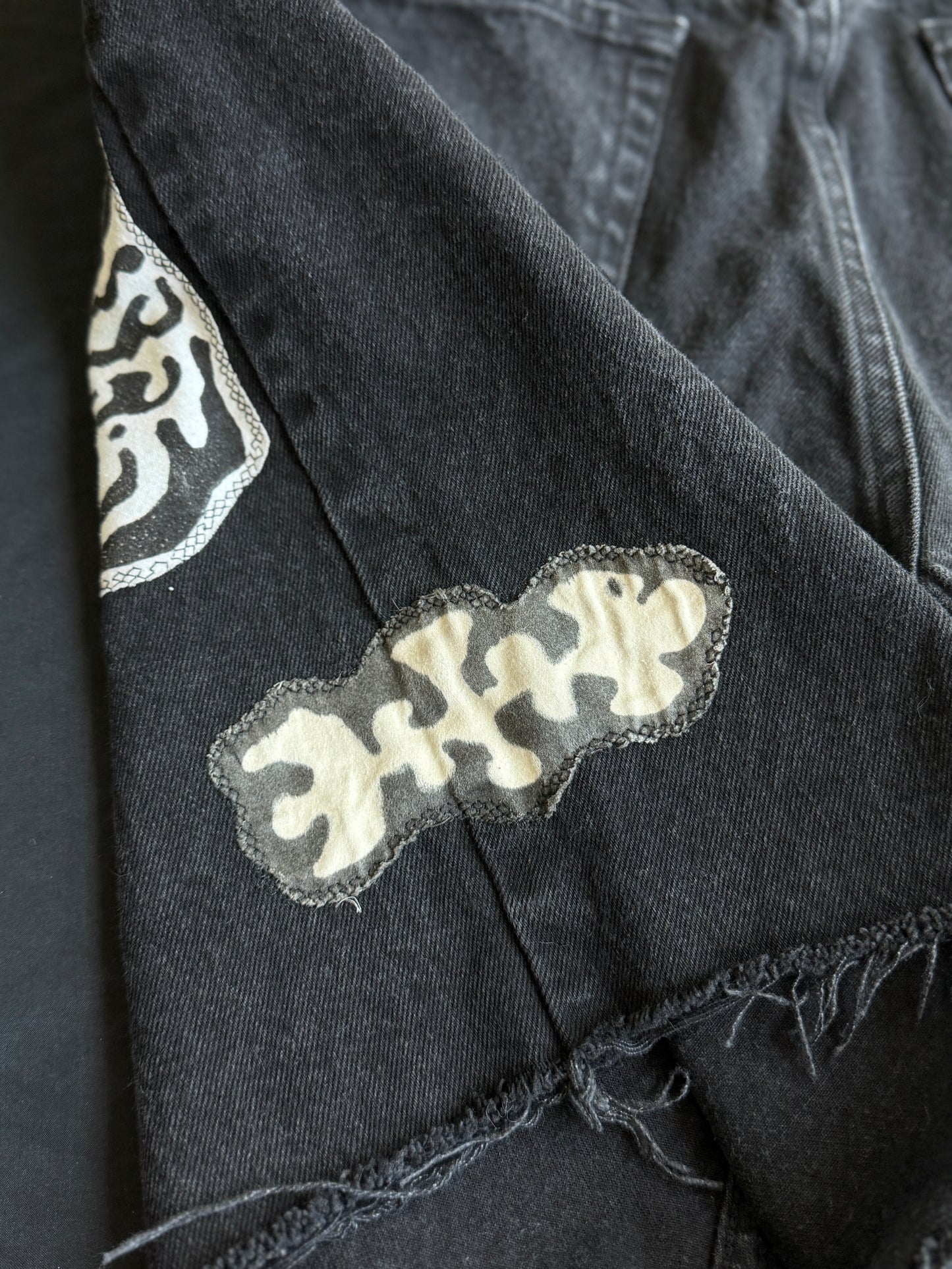 Black and white patch black jean shorts